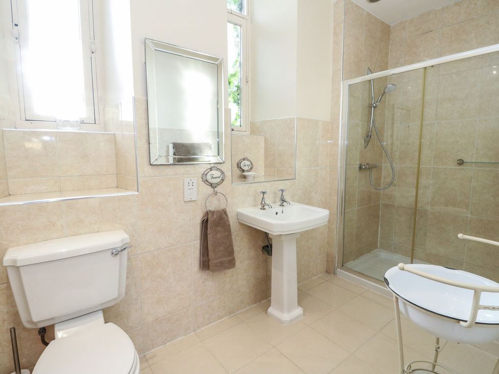 A bathroom with a sink, toilet, and shower at Newton Hall in Inveraray