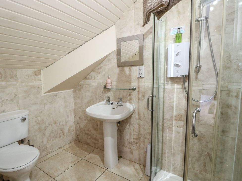 A bathroom with a toilet, sink, and shower at Newton Hall in Inveraray