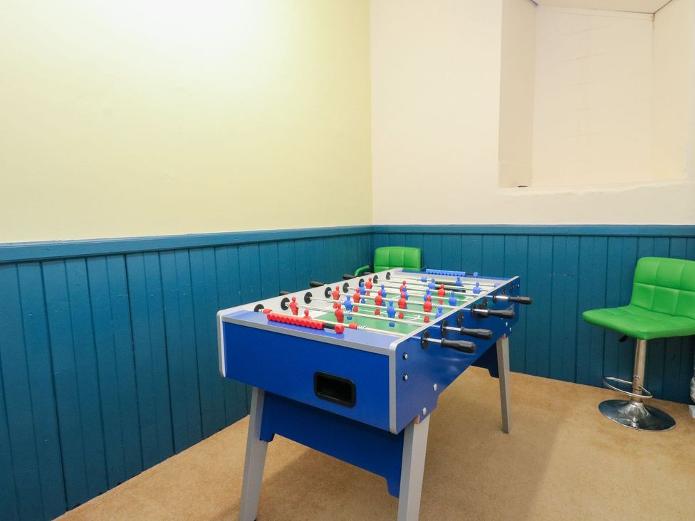 A foosball table with a green chair and bar stool at Newton Hall Inveraray