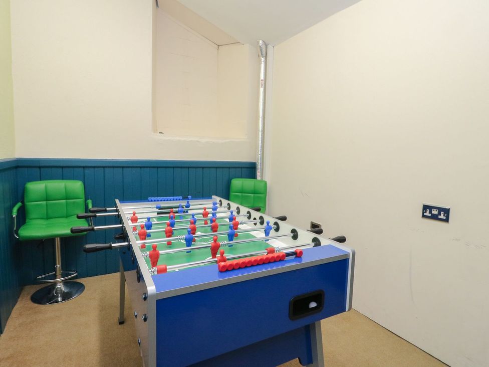A foosball table and green stools at Newton Hall in Inveraray