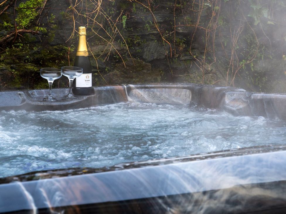 A hot tub with champagne and glasses at Newton Hall in Inveraray