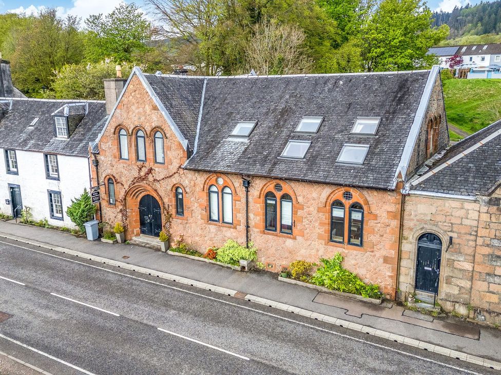 An exterior view of a building with a road in front at Newton Hall in Inveraray
