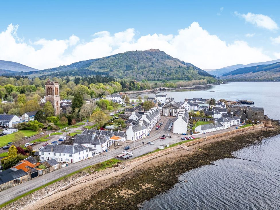 An aerial view of a village by a river at Newton Hall in Inveraray