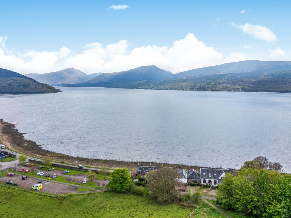 A view of a lake surrounded by mountains at Newton Hall in Inveraray