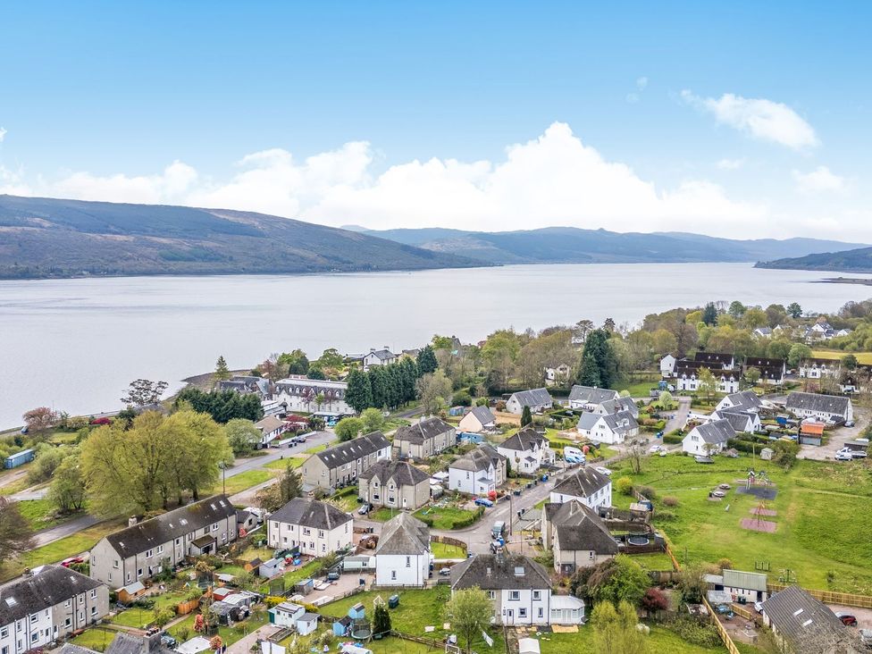 A view of residential area near a lake with houses and playground at Newton Hall in Inveraray