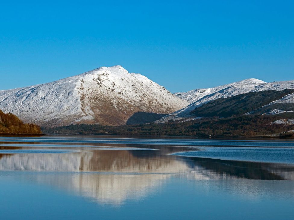 Mountains and water with reflection at Newton Hall in Inveraray