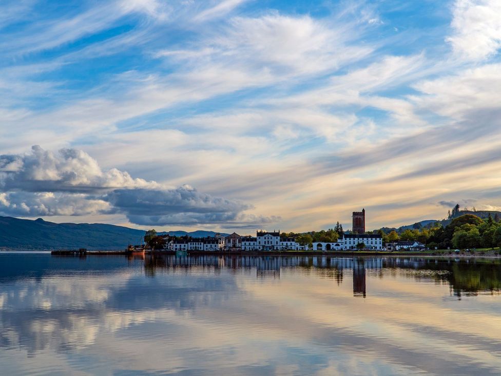 A landscape view with buildings and water at Newton Hall in Inveraray