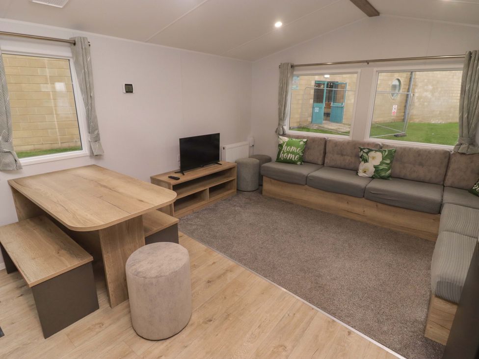 A living room with a sofa and a table at 47 Chestnut Road in Porthcawl