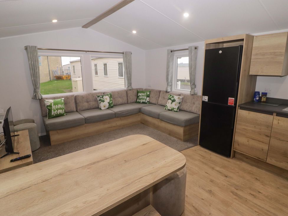 A living room with a sofa and coffee table at 47 Chestnut Road in Porthcawl