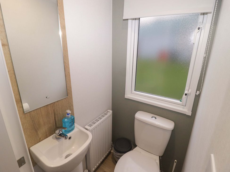 A bathroom with a sink and toilet at 47 Chestnut Road Porthcawl