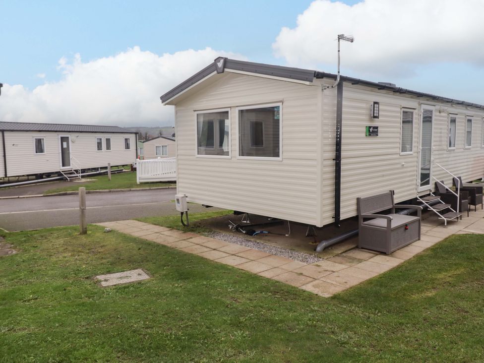 A static caravan with outdoor seating at 47 Chestnut Road Porthcawl