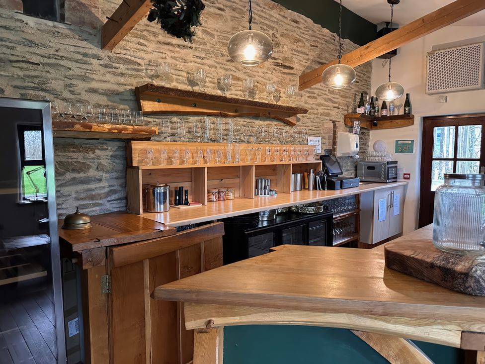 A bar area with shelves and glasses at Jabajak in Whitland