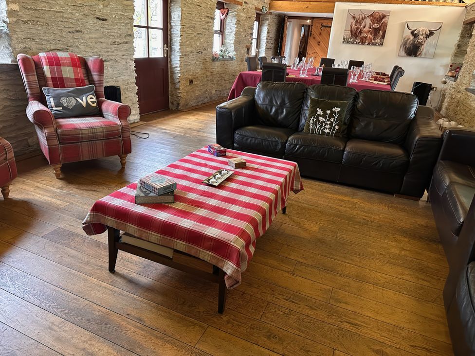A living room with armchair and sofa at Jabajak in Whitland