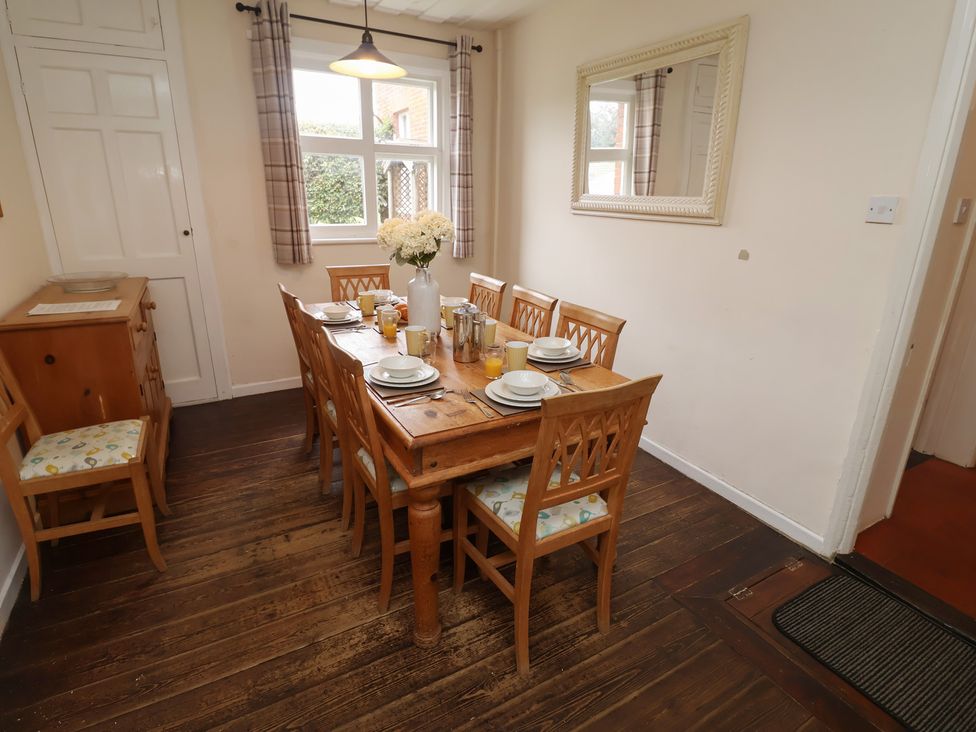 A dining room with a large table set for breakfast at Duke Cottage in Woodbridge