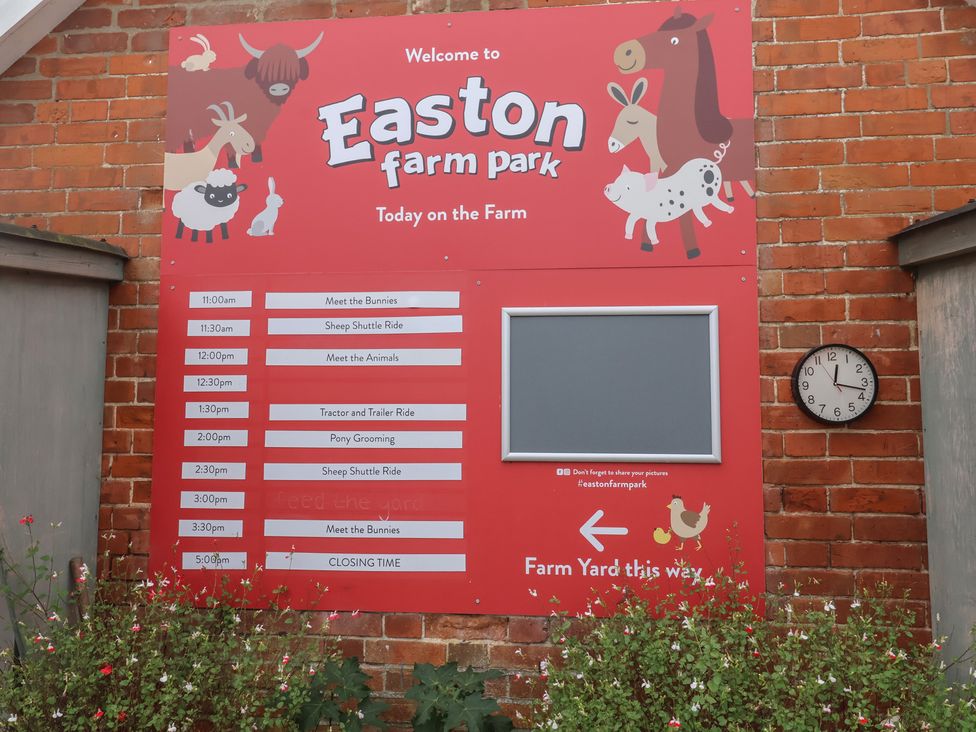 A sign with schedule and clock at Easton farm park in Woodbridge