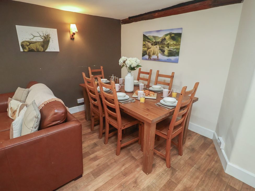 A dining room with a table set for meals at Duchess Cottage in Woodbridge