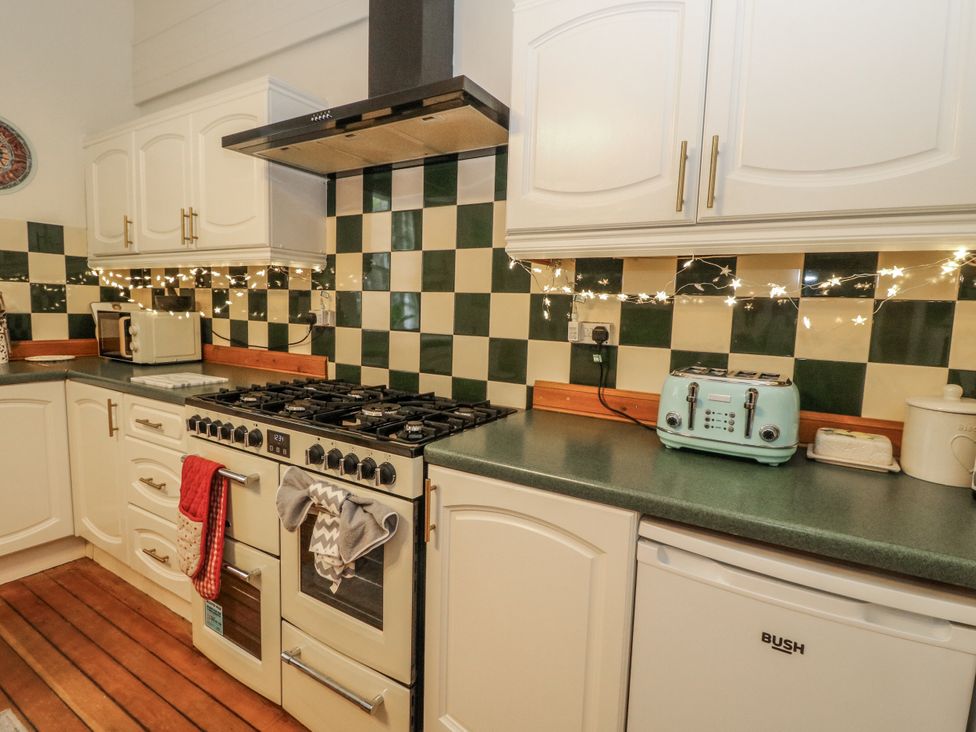 A kitchen with a stove and appliances at Rowan Tree House Brechin