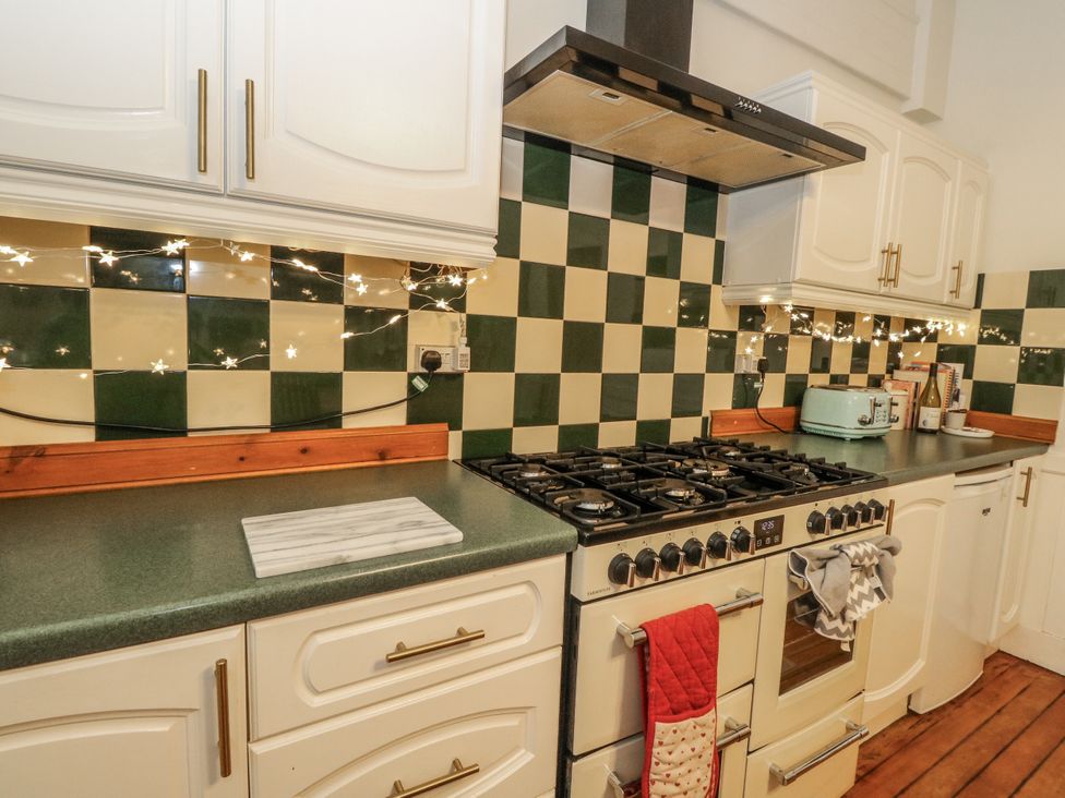 A kitchen with a stove and cabinets at Rowan Tree House in Brechin