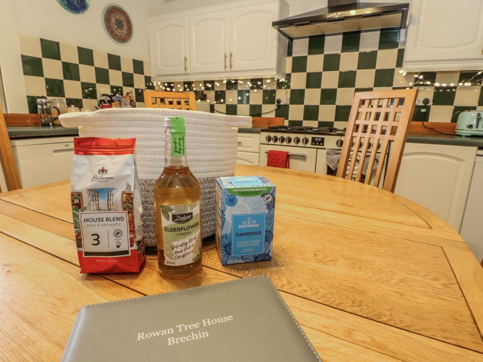 A kitchen with a table and tea items at Rowan Tree House Brechin