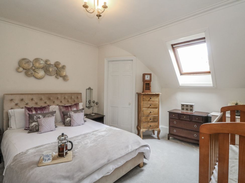A bedroom with a bed and furniture at Rowan Tree House Brechin
