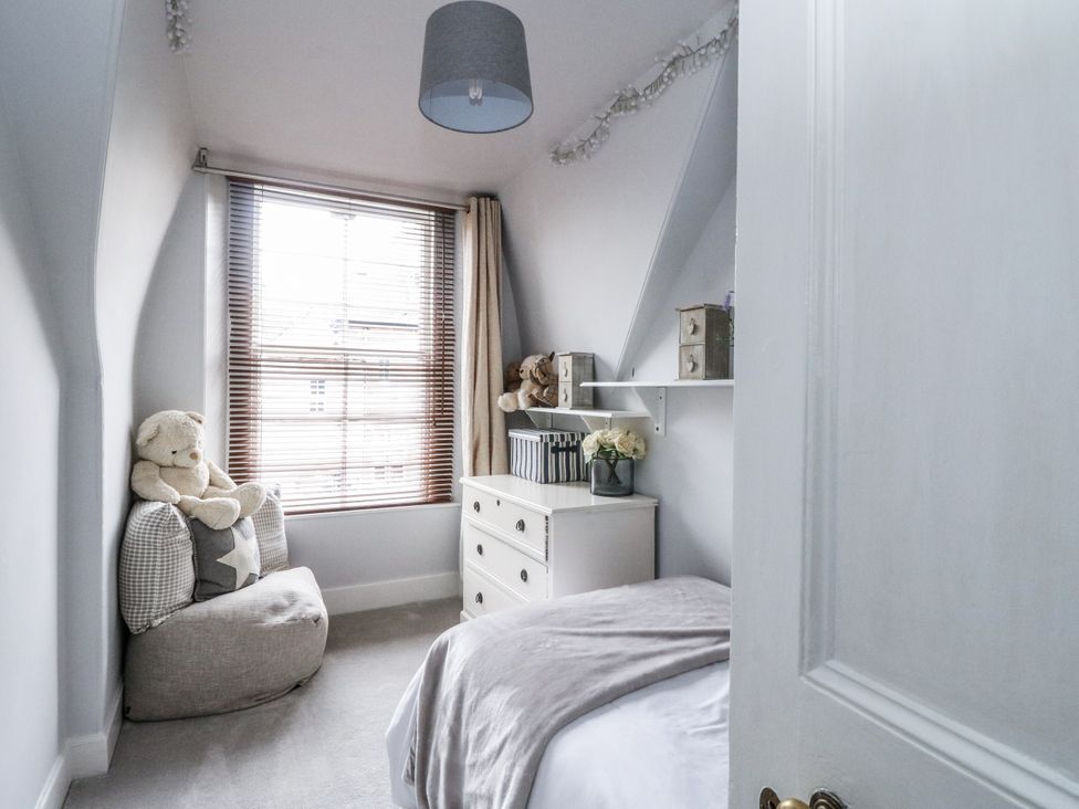 A bedroom with a bean bag and teddy bear at Rowan Tree House in Brechin
