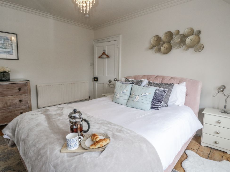 A bedroom with a bed and breakfast tray at Rowan Tree House in Brechin