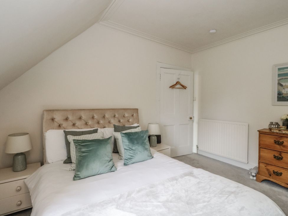 A bedroom with a bed and bedside tables at Rowan Tree House Brechin