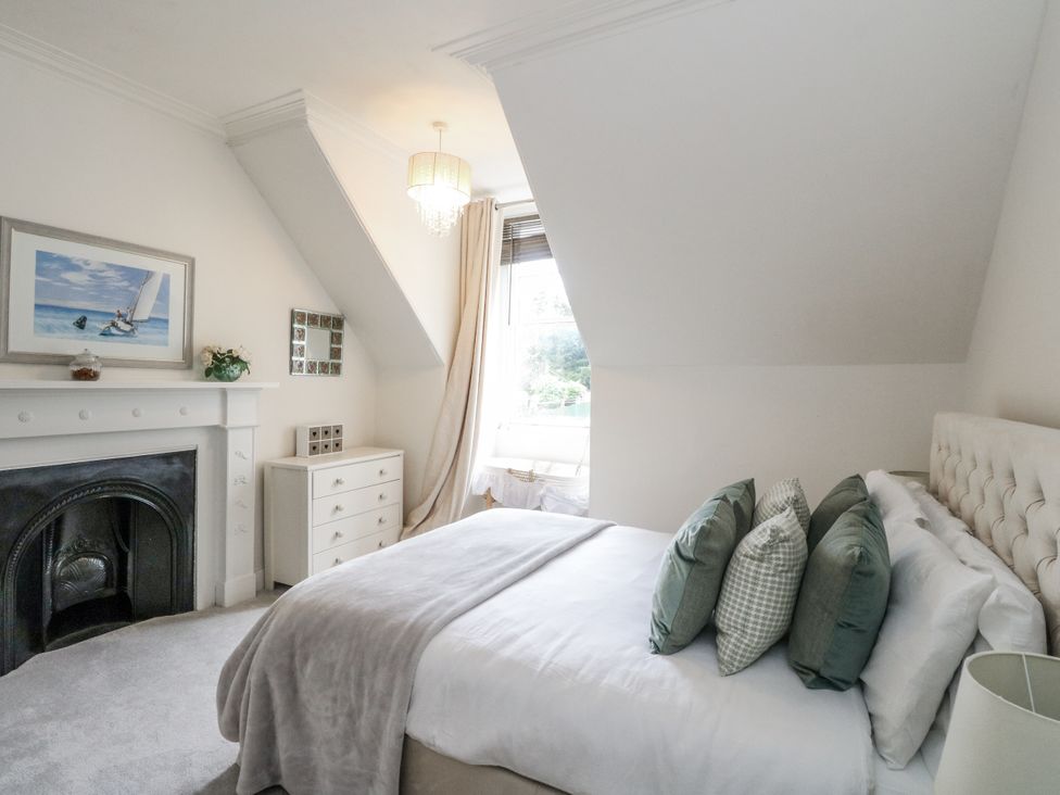 A bedroom with a bed and a fireplace at Rowan Tree House in Brechin