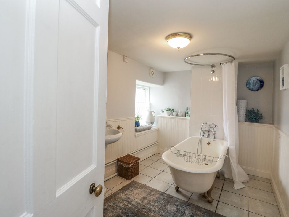 A bathroom with a bathtub and sink at Rowan Tree House in Brechin