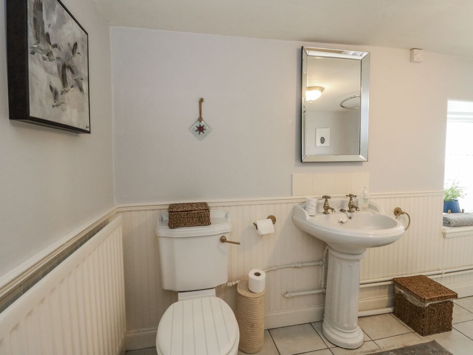 A bathroom with a sink and a toilet at Rowan Tree House in Brechin