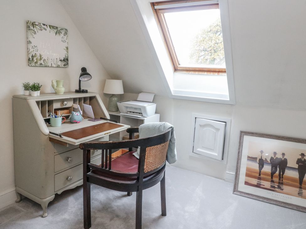 An office with a desk, chair, and lamp at Rowan Tree House in Brechin