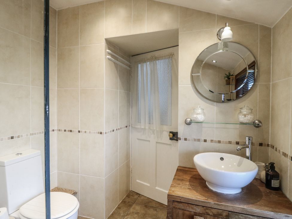 A bathroom with a toilet and sink at Rowan Tree House in Brechin