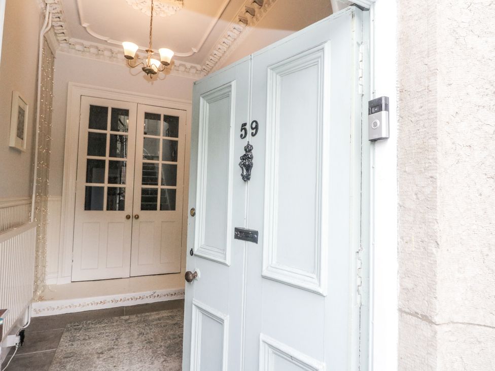 An entrance with a front door and closet doors at Rowan Tree House in Brechin
