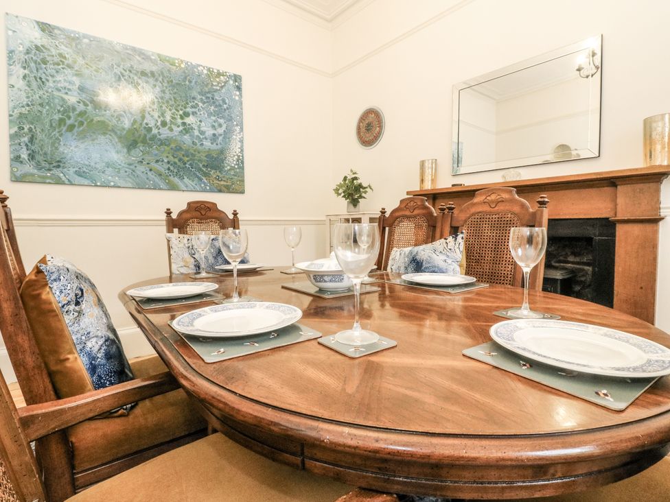 A dining room with a table set for dinner at Rowan Tree House in Brechin
