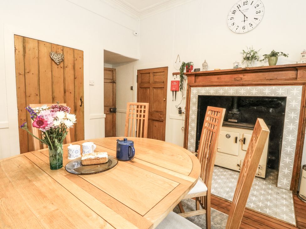 A dining room with a table and chairs at Rowan Tree House in Brechin