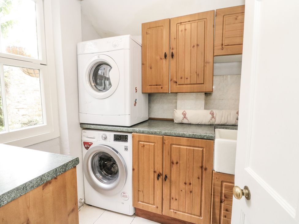 A laundry room with a washing machine and tumble dryer at Rowan Tree House in Brechin