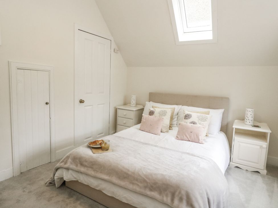 A bedroom with a bed and nightstands at Rowan Tree House in Brechin