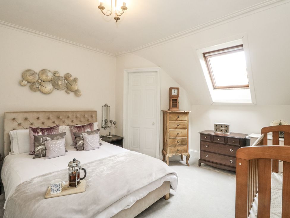 A bedroom with a bed and furniture at Rowan Tree House Brechin