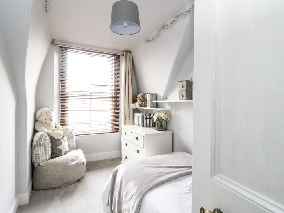 A bedroom with a dresser and a bean bag at Rowan Tree House in Brechin