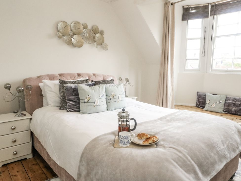 A bedroom with a bed and nightstand at Rowan Tree House in Brechin