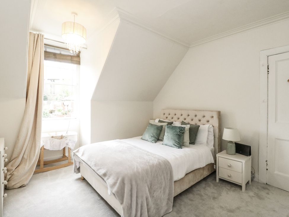 A bedroom with a bed and window at Rowan Tree House in Brechin