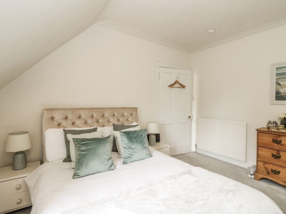 A bedroom with a bed and bedside lamp at Rowan Tree House in Brechin