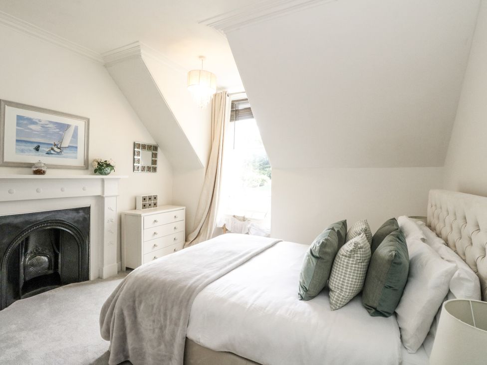 A bedroom with a bed and chest of drawers at Rowan Tree House in Brechin