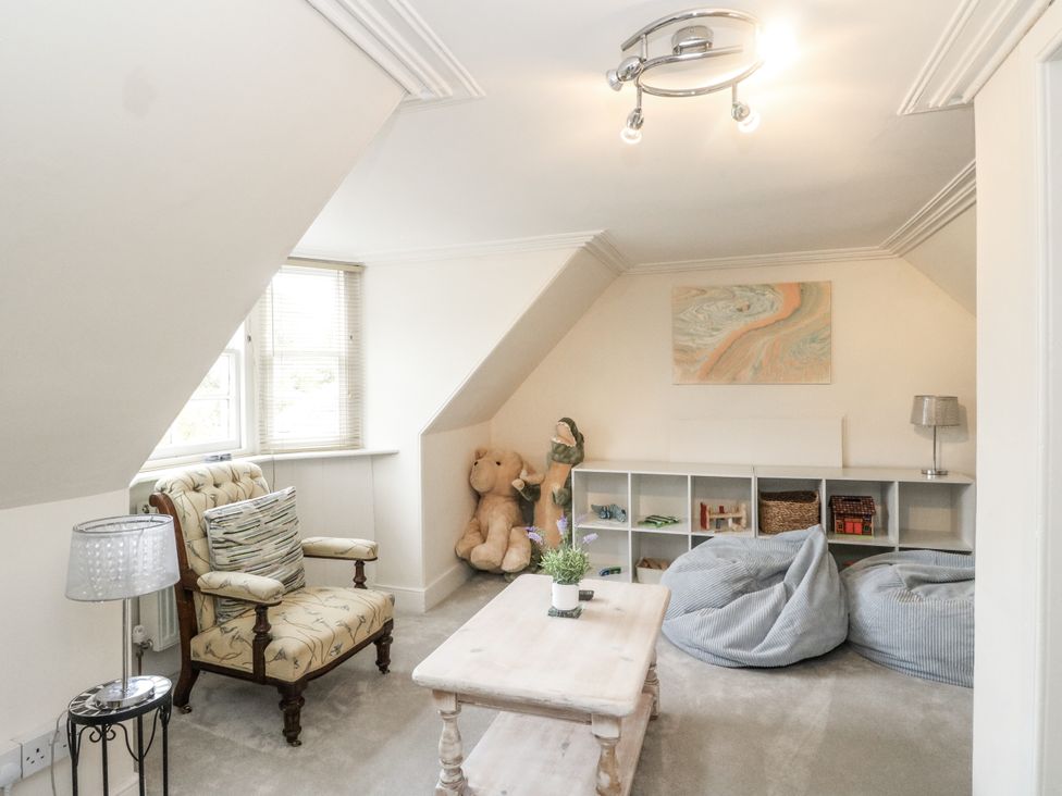 A snug with an armchair and coffee table at Rowan Tree House in Brechin