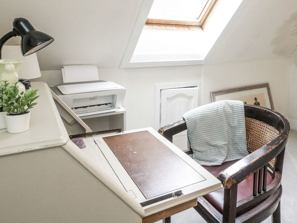 An office with a desk, lamp, printer, chair and plant at Rowan Tree House in Brechin