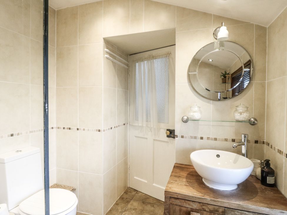 A bathroom with a toilet and sink at Rowan Tree House Brechin