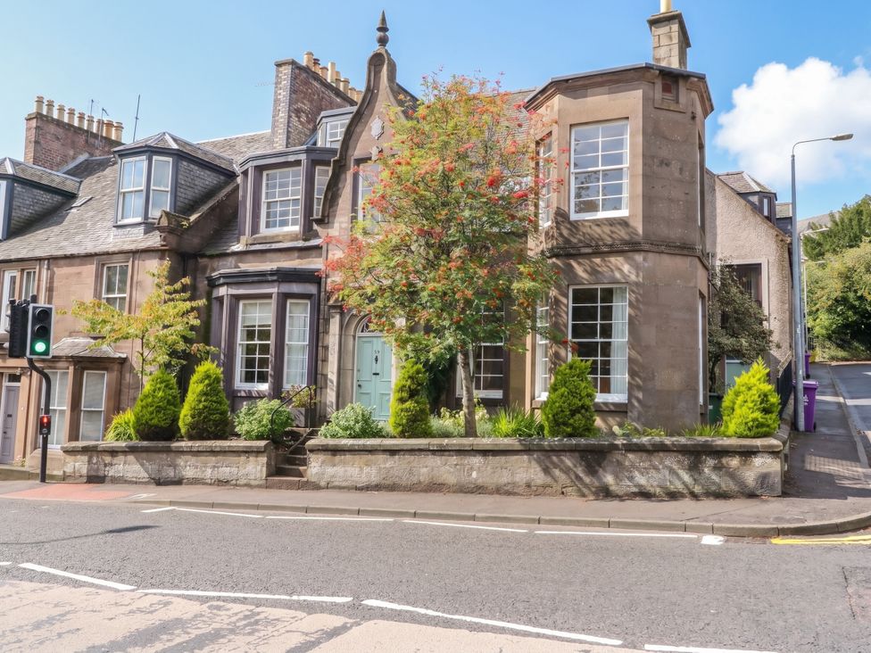 A house with trees and a traffic light at Rowan Tree House Brechin