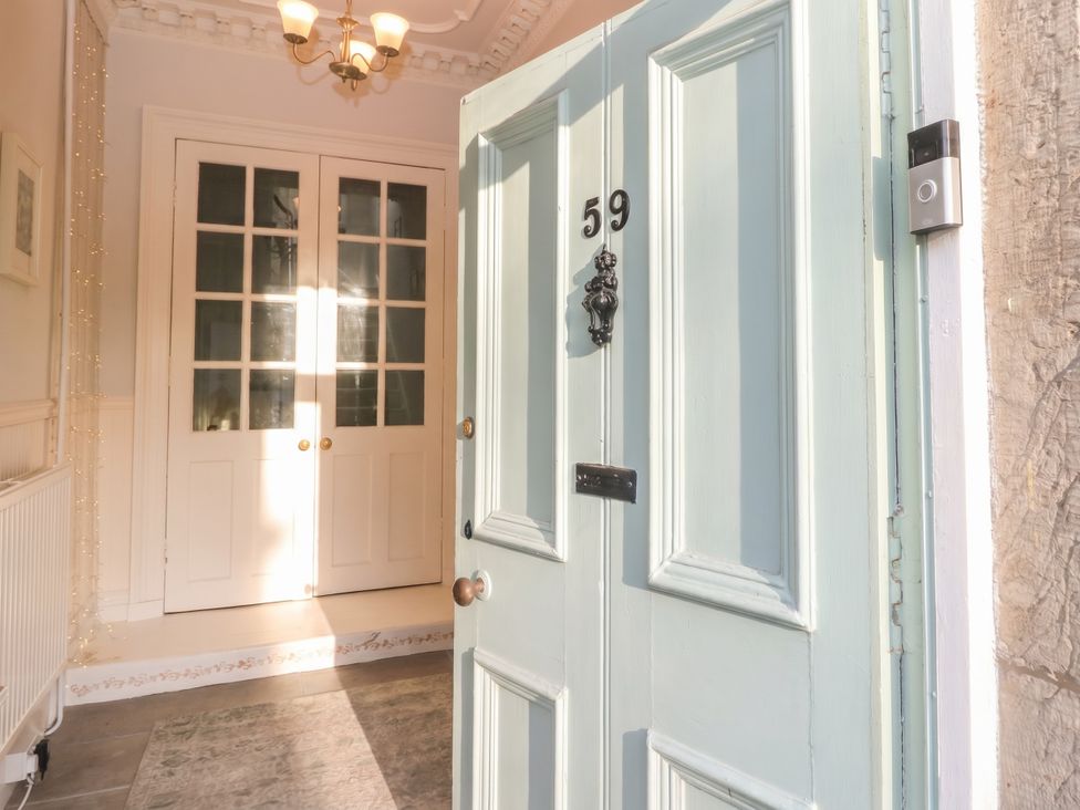 An entrance hallway with a front door and interior doors at Rowan Tree House Brechin