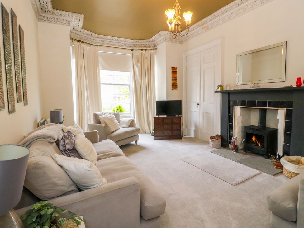 A living room with a sofa and television at Rowan Tree House Brechin