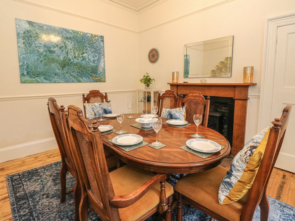 A dining room with a table set for dinner at Rowan Tree House in Brechin